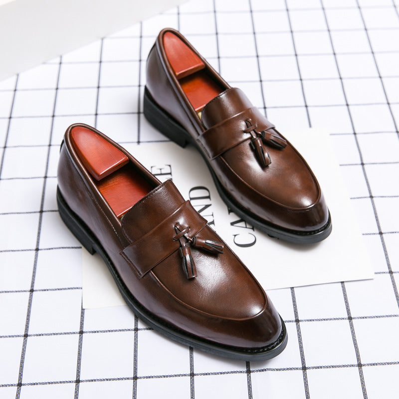 Brown leather tassel loafers with black soles and red lining, men’s classic