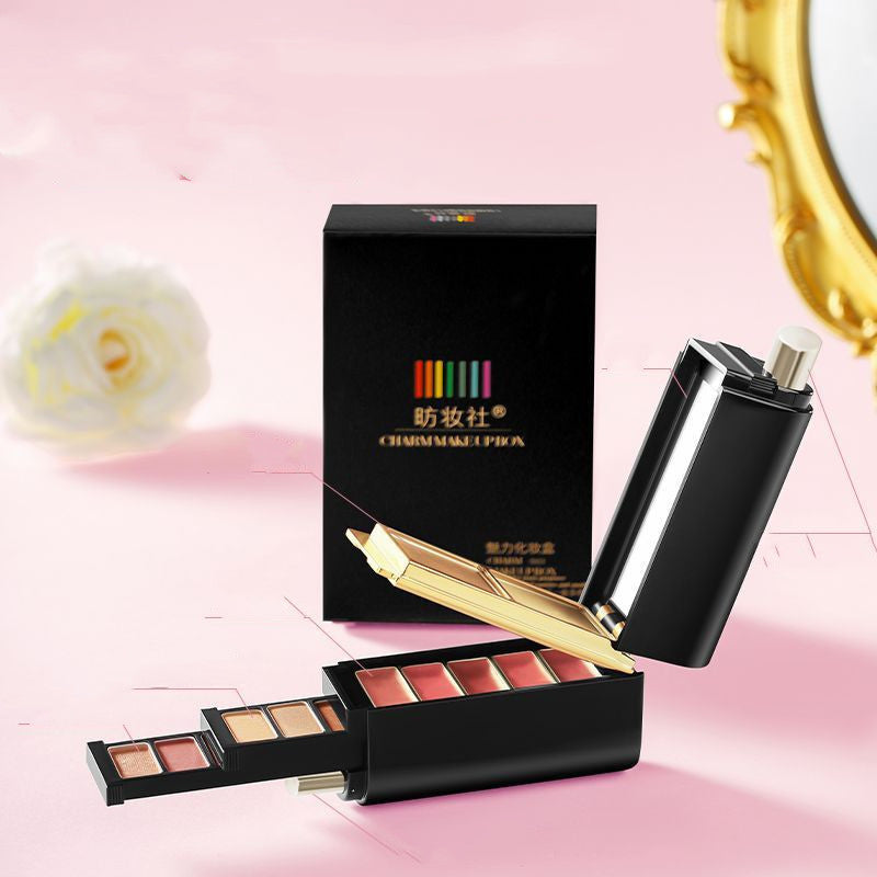 Makeup set with a black box and applicator on a pink background
